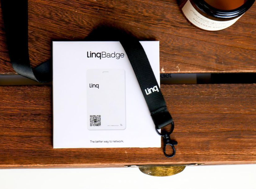 packaging for a custom tag that is used at a conference on a wood table